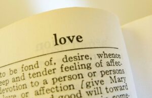 Open book with the definition of love written in text. 