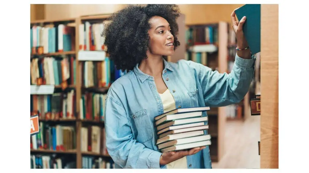 Black woman in a library researching for books.
