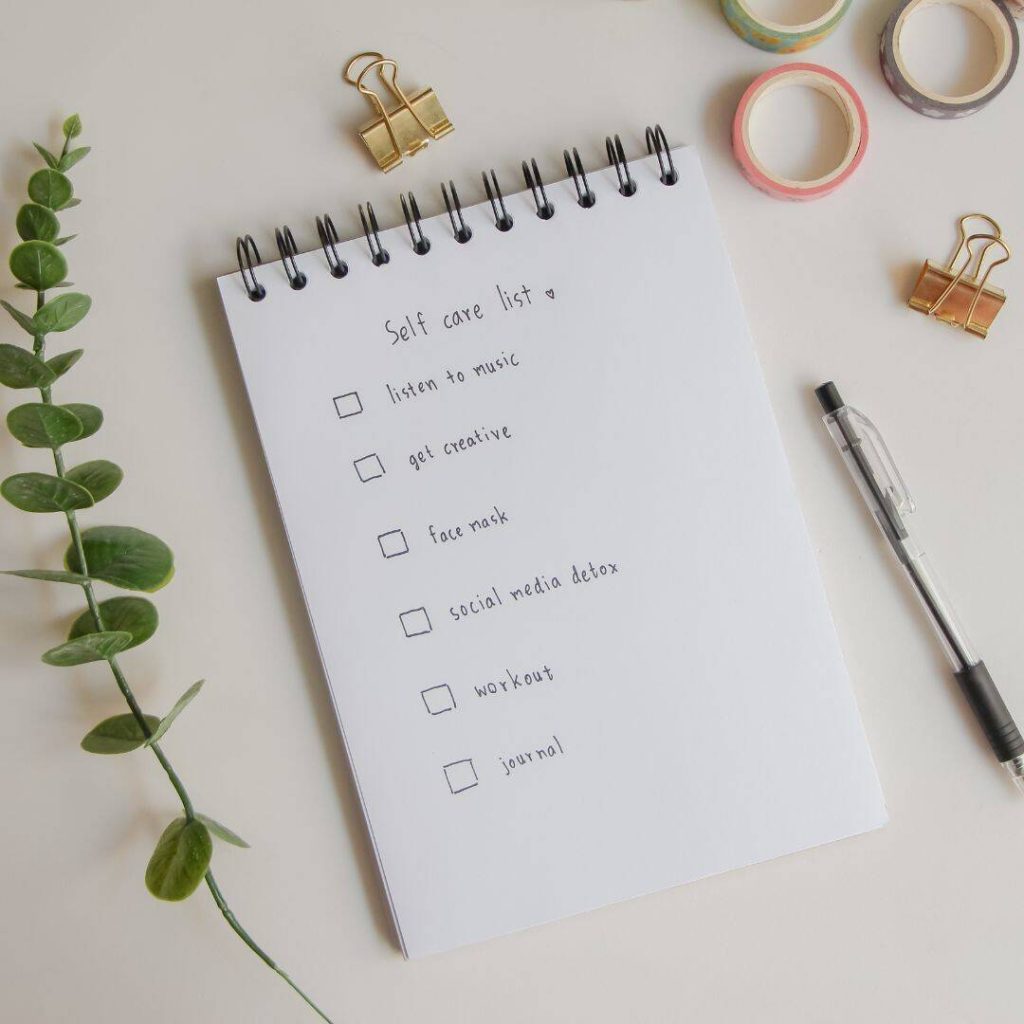 Self-care checklist written on notebook paper which includes creativity.