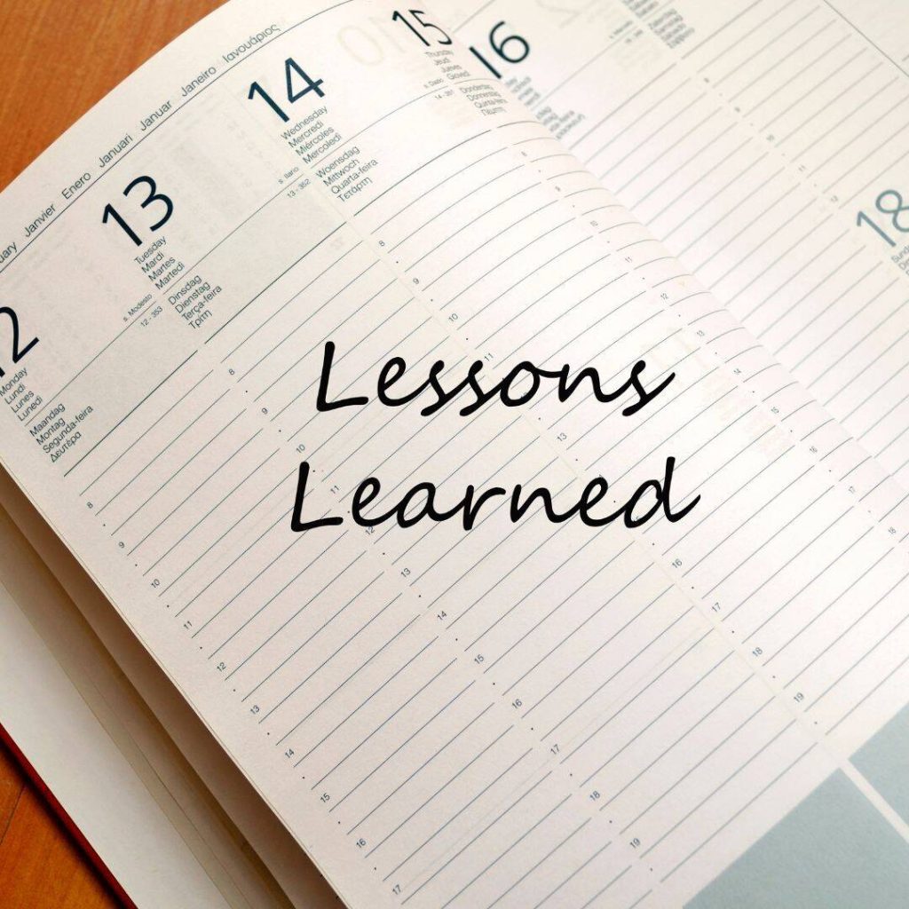 Lessons learned written in black in a planner/ black and white notebook.